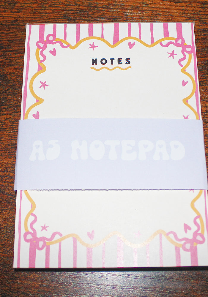 Notebook with decorative cover on a wooden surface