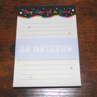 Load image into Gallery viewer, Notepad with 'One step at a time' text on a wooden surface
