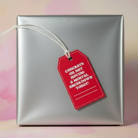 Load image into Gallery viewer, Silver gift box with a red tag on a blurred background
