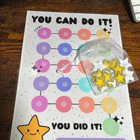 Load image into Gallery viewer, Motivational chart with colorful circles and stars on a wooden surface
