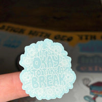 Load image into Gallery viewer, Light blue sticker with text 'its okay to take a break' held over sticker sheets
